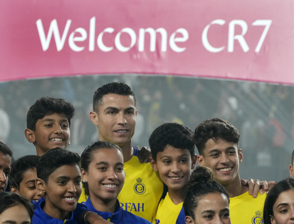Cristiano Ronaldo poses with young players during his official unveiling as a new member of Al Nassr soccer club in in Riyadh, Saudi Arabia, Tuesday, Jan. 3, 2023. Ronaldo, who has won five Ballon d'Ors awards for the best soccer player in the world and five Champions League titles, will play outside of Europe for the first time in his storied career. (AP Photo/Amr Nabil)