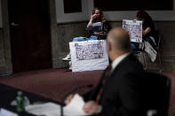 Victims of the Ethiopian Airlines Flight 302 Boeing 737 Max 8 crash including Samya Stumo are seen as Federal Aviation Administration administrator Stephen Dickson waits to speak during a hearing of the Senate Commerce, Science, and Transportation Committee on Capitol Hill Wednesday, June 17, 2020, in Washington. (Brendan Smialowski/Pool via AP)