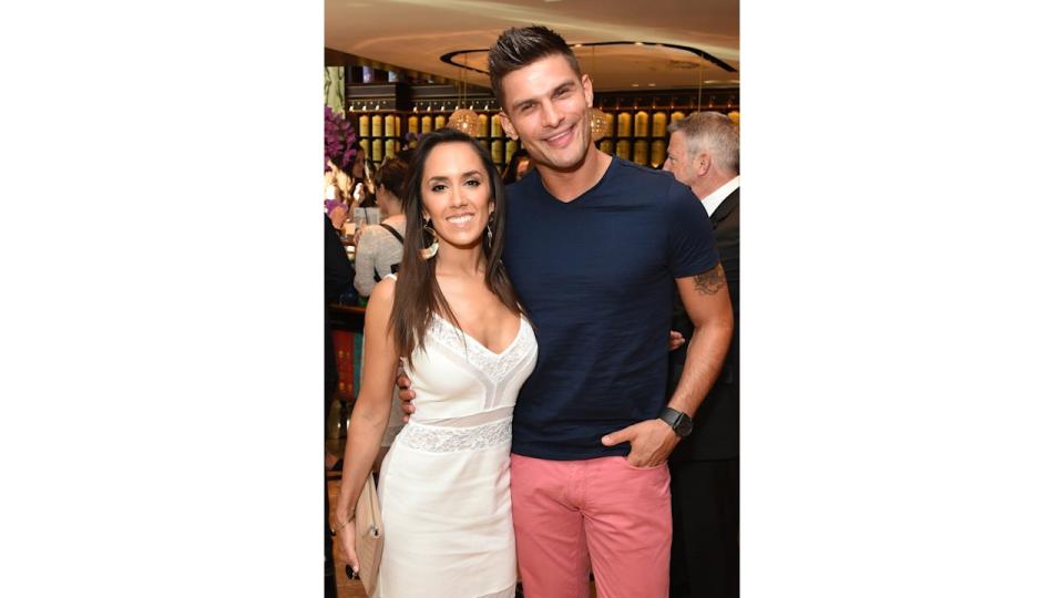 Janette Manrara in a white dress and Aljaz Skorjanec in a blue t-shirt and salmon-coloured trousers