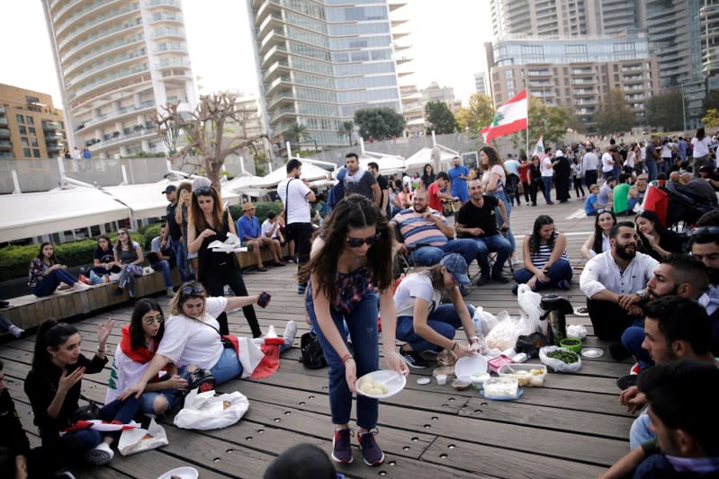 Protesters take part in the ongoing anti-government protests in Beirut