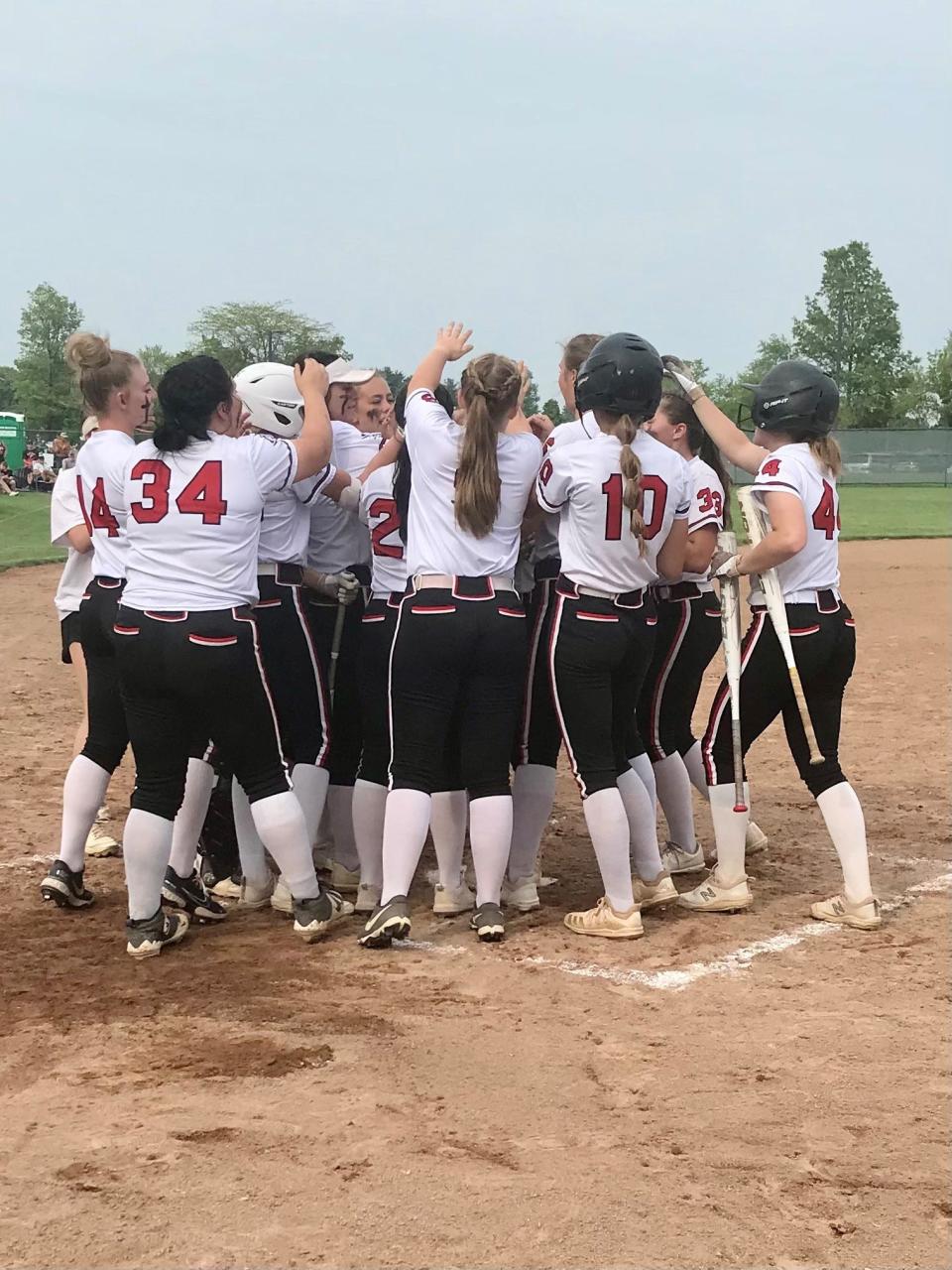 The Pirates celebrate a two-run home run hit by Haliee Edgell during a Division III district championship softball game Friday night at Pickerington Central.