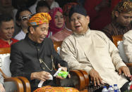 FILE - In this Sept. 23, 2018 file photo, Indonesian President Joko Widodo, left, and his contender Prabowo Subianto share a light moment during a ceremony marking the kick off of the campaign period for next year's election in Jakarta, Indonesia. Echoing the campaign tactics of Donald Trump, former Indonesian Gen. Prabowo Subianto says his country, the world's third-largest democracy, is in dire shape and he is the leader who will restore it to greatness. (AP Photo/Tatan Syuflana, File)