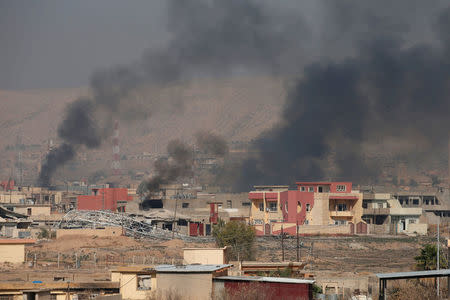 Smoke rises during clashes between Peshmerga forces and Islamic State militants in the town of Bashiqa, east of Mosul, during an operation to attack Islamic State militants in Mosul, Iraq, November 7, 2016. REUTERS/Azad Lashkari