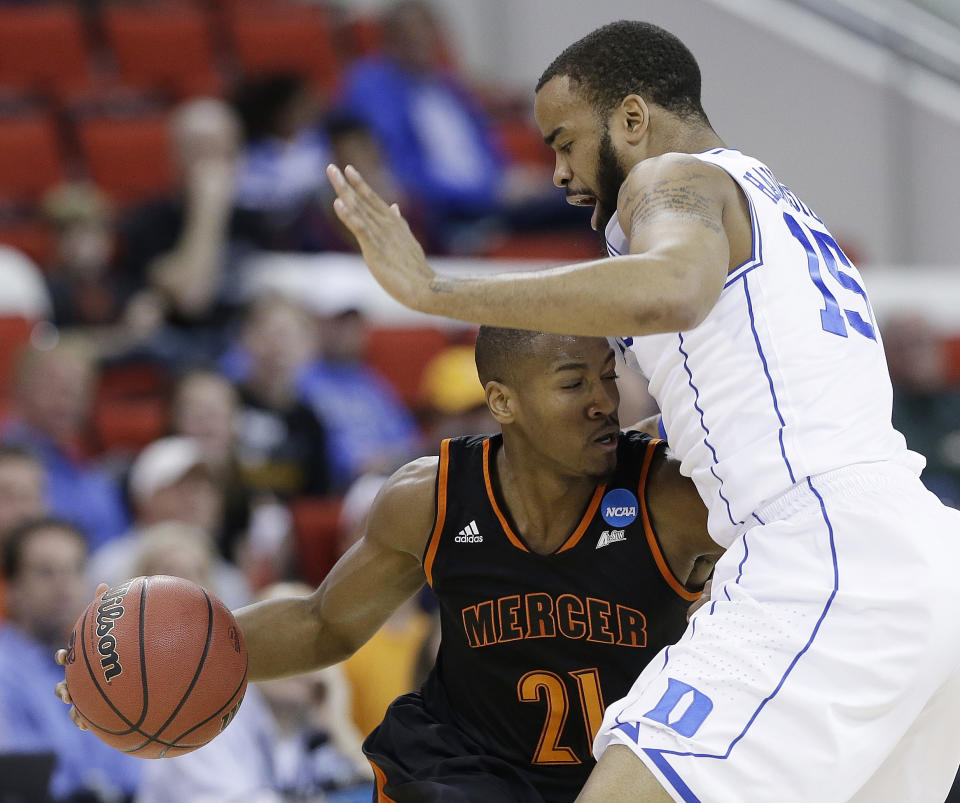 Mercer guard Langston Hall (21) runs into Duke forward Josh Hairston (15) during the first half of an NCAA college basketball second-round game, Friday, March 21, 2014, in Raleigh, N.C. (AP Photo/Gerry Broome)
