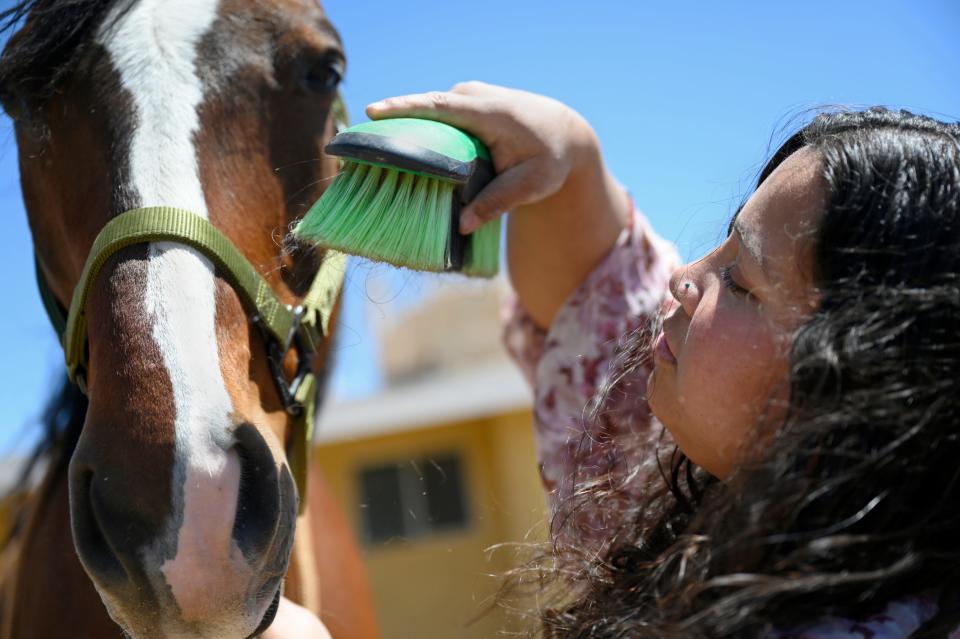 Army Veteran Clarice Sykes, 28, brushes her horse Denali on Thursday, April 25, 2024 in Victorville. Clarice suffered a freak accident in July 2018 leaving her without legs but continues to pursue her passion with horses and intends to open her own ranch where she will cater to people of all ages, but especially to children and veterans with disabilities.