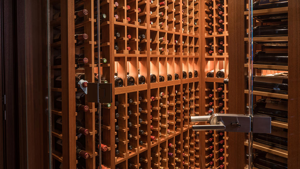 The custom teak wine cellar aboard the Endless Summer yacht. - Credit: Courtesy of Westport Yachts