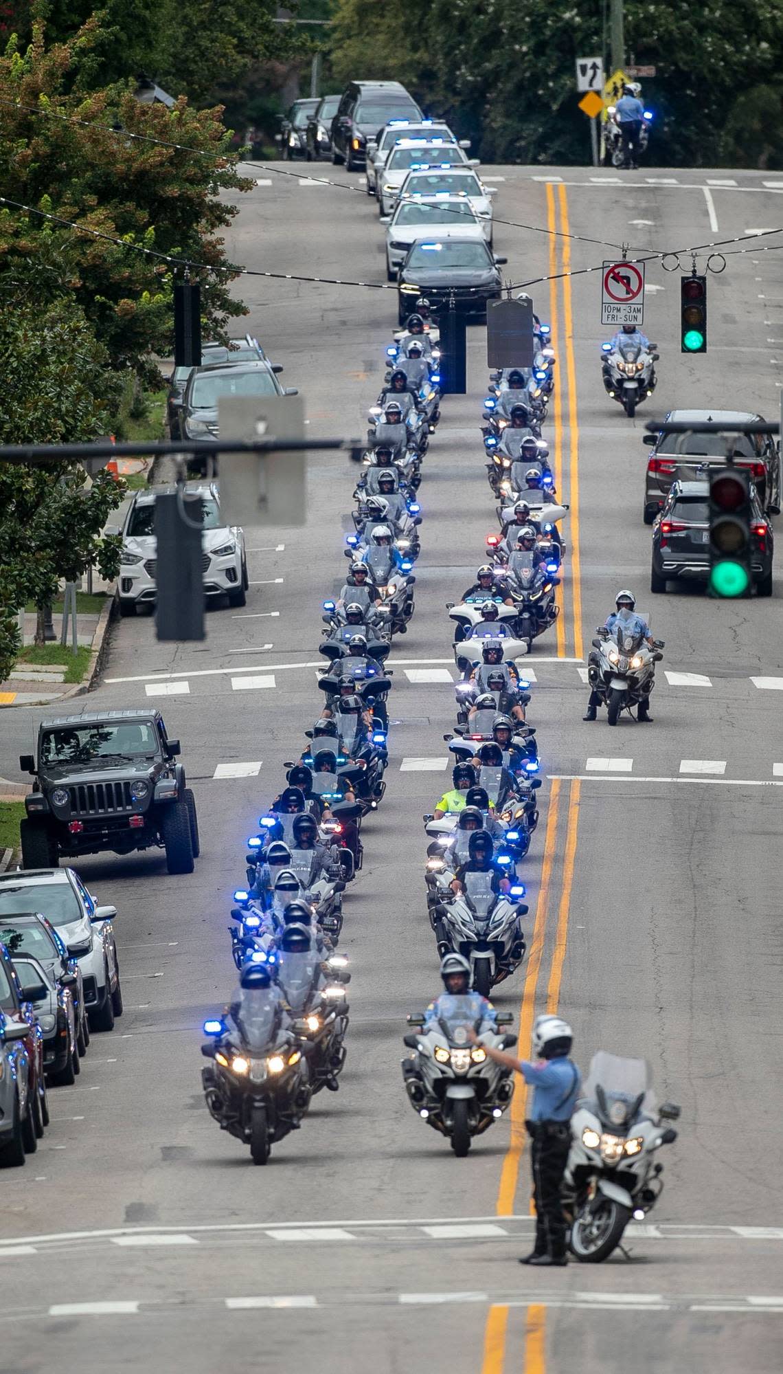 The funeral recessional for Wake County Deputy Ned Byrd makes it way down Glenwood Avenue toward Brown-Wynne Funeral Home on St Marys Street following the service at Providence Baptist Church on Friday, August 19, 2022 in Raleigh, N.C.