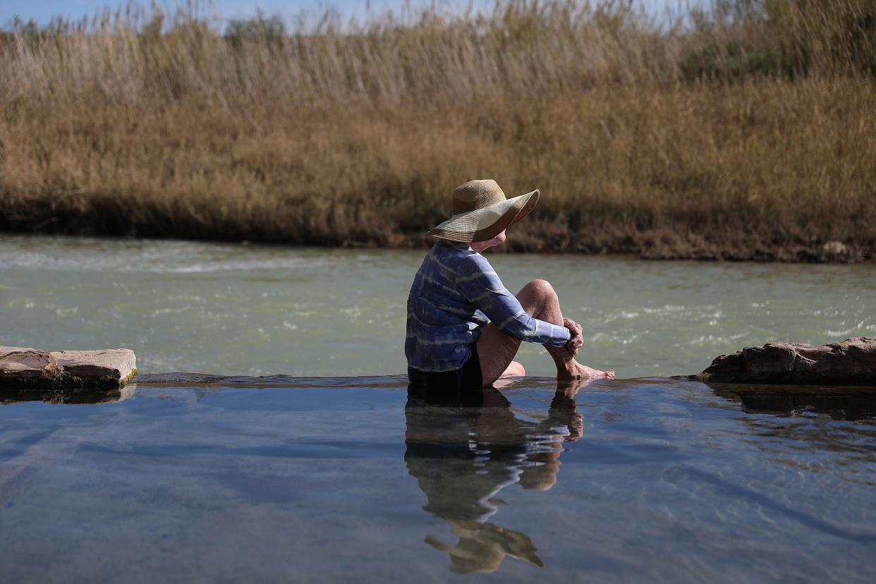 Cindy Burns sits in a hot spring next to the Rio Grande river that marks the boundary between the United States and Mexico on Jan. 17, 2019 in Big Bend National Park.