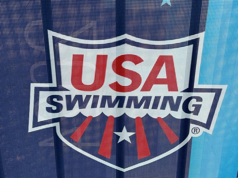The USA Swimming logo on a barricade along Georgia Street.