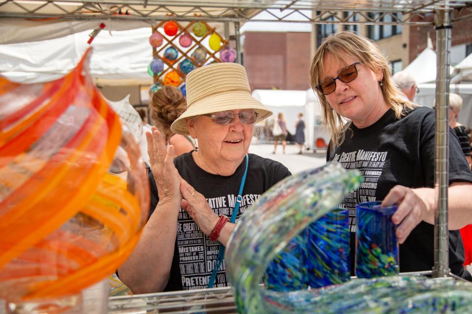 Shirley Ehlers and her daughter Kirsten Ehlers check out Karen and Angelo's glassblowing at the Des Moines Arts Festival in 2021.