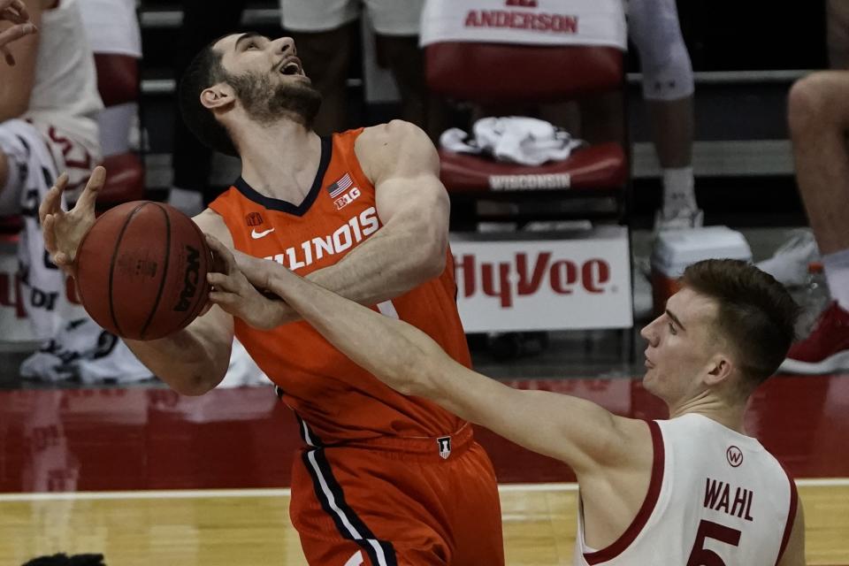 Wisconsin's Tyler Wahl blocks the shot of Illinois's Giorgi Bezhanishvili during the first half of an NCAA college basketball game Saturday, Feb. 27, 2021, in Madison, Wis. (AP Photo/Morry Gash)