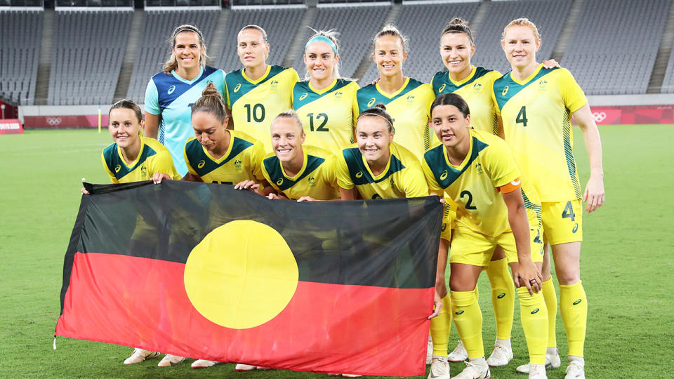 The Matildas joined together and held the Aboriginal Flag up ahead of their opening match at the Tokyo Olympic Games. (Getty Images)