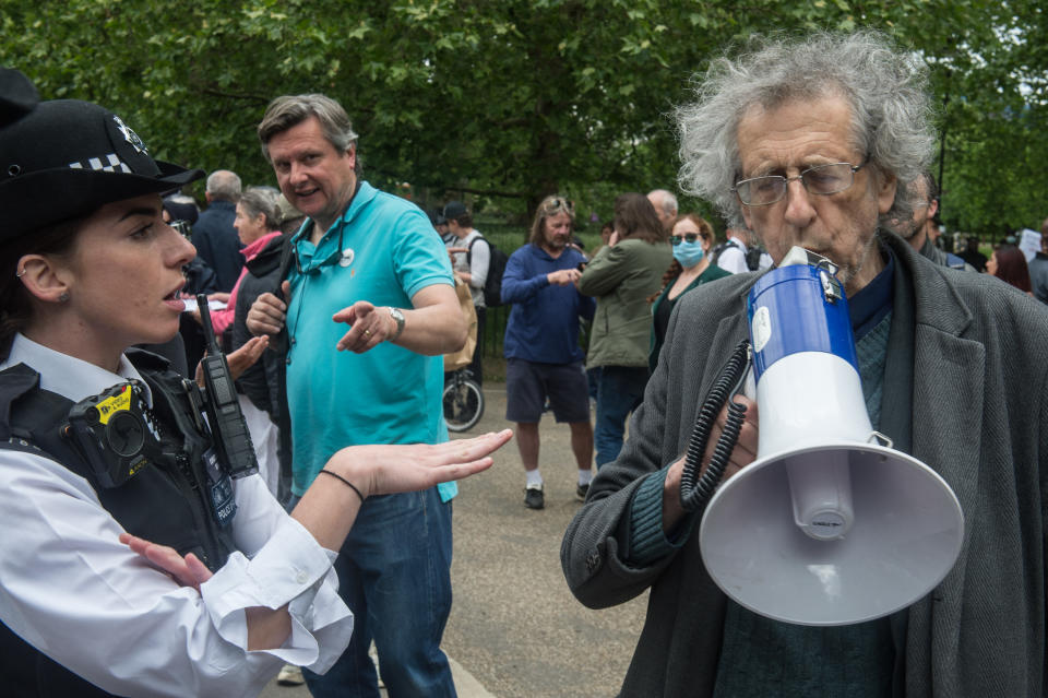 LONDON, ENGLAND - MAY 16: Piers Corbyn (brother of former Labour leader Jeremy Corbyn) is spoken to by the Police as conspiracy theorists gather at Hyde Park Corner to defy the emergency legislation and protest their claim that the Coronavirus pandemic is part of a secret conspiracy on May 16, 2020 in London, United Kingdom. The prime minister has announced the general contours of a phased exit from the current lockdown, adopted nearly two months ago in an effort curb the spread of Covid-19. (Photo by Guy Smallman/Getty images)