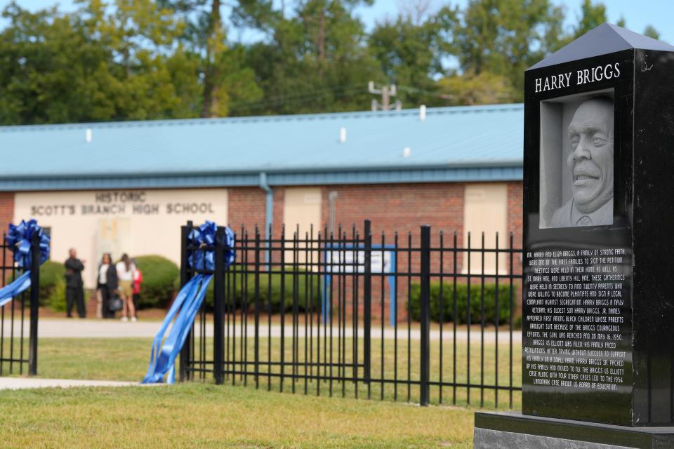 A marker to Harry Briggs, one of the plaintiffs in a lawsuit that led to the U.S. Supreme Court's historic Brown v. Board 1954 decision declaring segregated schools illegal, is shown outside Scott's Branch High School in Summerton, S.C., on Tuesday, Sep. 27, 2022. Interior Secretary Deb Haaland visited the school as part of a trip to South Carolina marking the acquisition of Scott's Branch and another high school by the National Park Service in an effort to protect sites related to Brown v. Board. (AP Photo/Meg Kinnard)