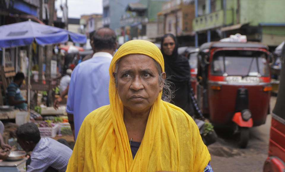 A Sri Lankan Muslim woman walks in a market street in Colombo, Sri Lanka, Tuesday, Aug. 27, 2019. Islamic clerics in Sri Lanka asked Muslim women on Tuesday to continue to avoid wearing face veils until the government clarifies whether they are once again allowed now that emergency rule has ended four months after a string of suicide bomb attacks. (AP Photo/Eranga Jayawardena)