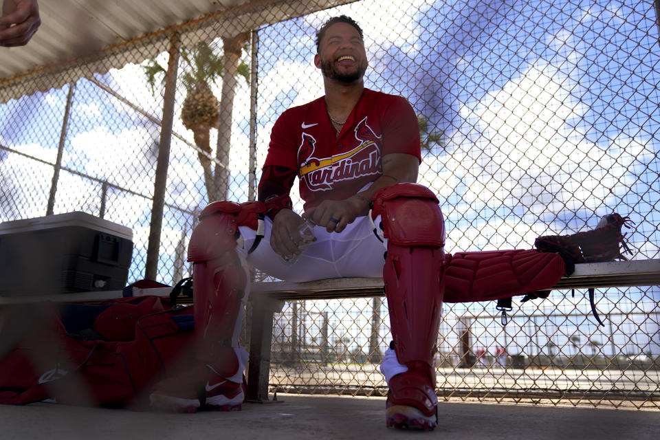St. Louis Cardinals catcher Willson Contreras laughs as he sits in a dugout during spring training baseball practice Wednesday, Feb. 15, 2023, in Jupiter, Fla. (AP Photo/Jeff Roberson)