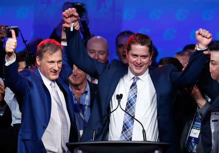 Maxime Bernier (L) celebrates with Andrew Scheer after Scheer's leadership win during the Conservative Party of Canada leadership convention in Toronto, Ontario, Canada May 27, 2017. REUTERS/Chris Wattie