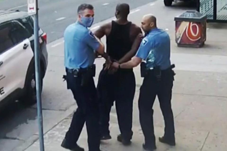 This image from video shows Thomas Lane, left and J. Alexander Kueng, right, escorting George Floyd to a police vehicle on May 25, 2020  (AP)