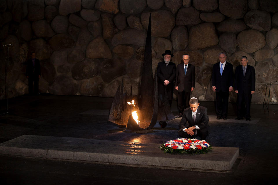 <p>President Barack Obama pays his respects in the Hall of Remembrance in front of Israel’s President Shimon Peres, Israel’s Prime Minster Benjamin Netanyahu, Chairman of the Yad Vashem Directorate Avner Shalev and Rabbi Yisrael Meir Lau after marines layed a wreath on his behalf during his visit to the Yad Vashem on March 22, 2013 in Jerusalem, Israel. This is Obama’s first visit as president to the region and his itinerary includes meetings with the Palestinian and Israeli leaders as well as a visit to the Church of the Nativity in Bethlehem. (Uriel Sinai/Getty Images) </p>