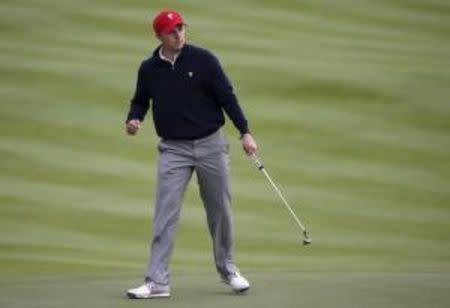 U.S. team member Jordan Spieth reacts after sinking his putt on the ninth hole during their four ball matches of the 2015 Presidents Cup golf tournament at the Jack Nicklaus Golf Club in Incheon, South Korea, October 10, 2015. REUTERS/Toru Hanai