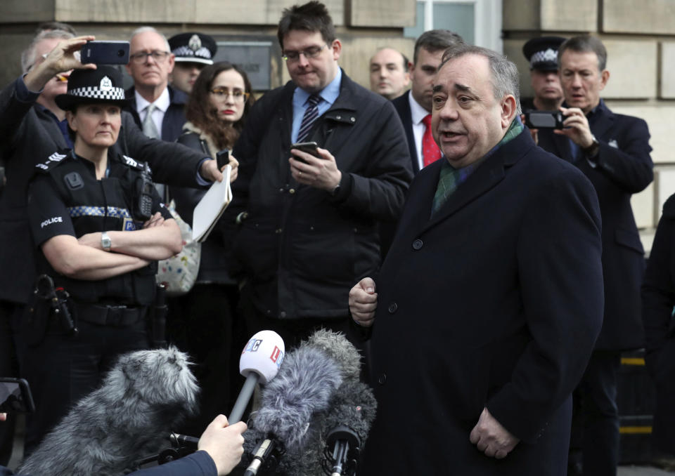 Former Scottish leader Alex Salmond, center, speaks to the media after leaving the High Court in Edinburgh, Thursday Nov. 21, 2019. Salmond, one of the country's best-known politicians, appeared in court faces a total of 14 charges of attempted rape, sexual assault and indecent assault against 10 women. (Andrew Milligan/PA via AP)