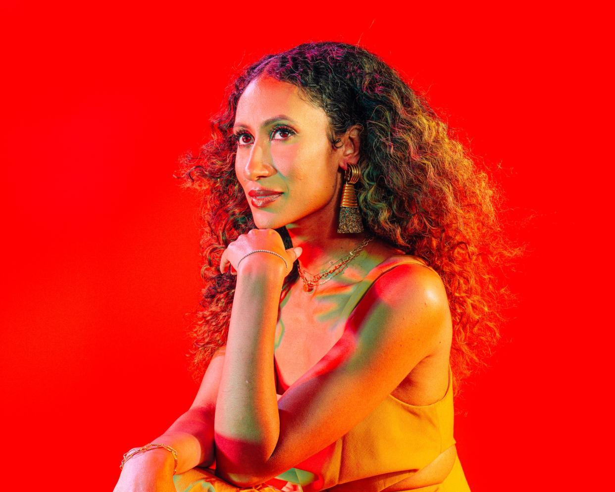 Elaine Welteroth portrait against a bright red background
