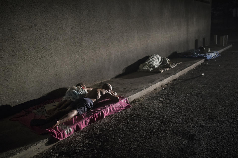 People sleep outside their homes for fresh air while air conditioning is not working during a blackout in the sweltering city of Maracaibo, Venezuela, May 15, 2019. Some of the most acute misery plays out every day on the streets of Maracaibo, Venezuela's second-largest city and a hub of the once-booming oil industry. (AP Photo/Rodrigo Abd)