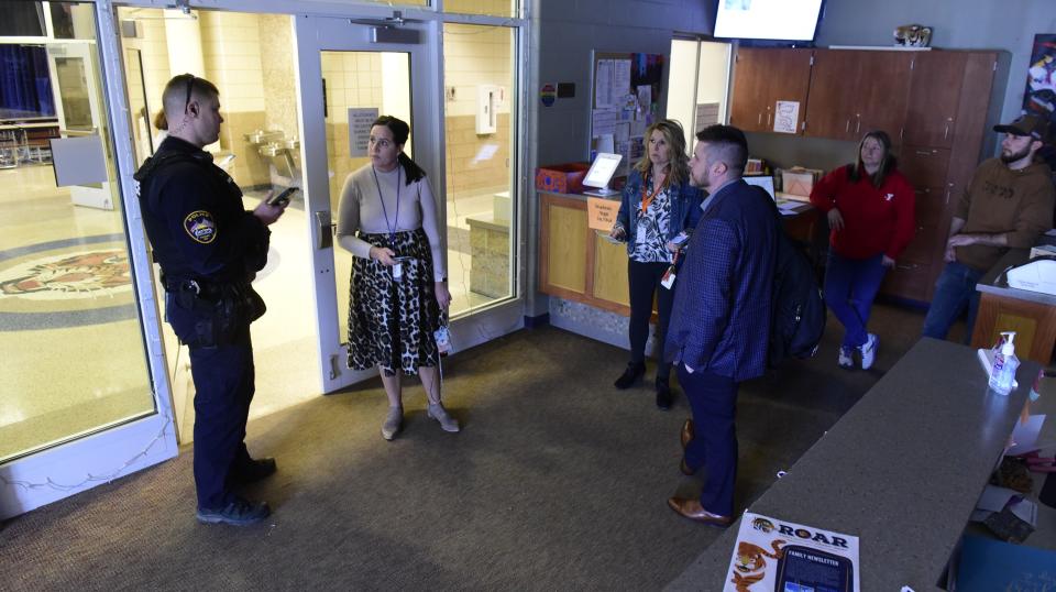 District staff and law enforcement touch base during a lockdown drill inside Galion Middle School.