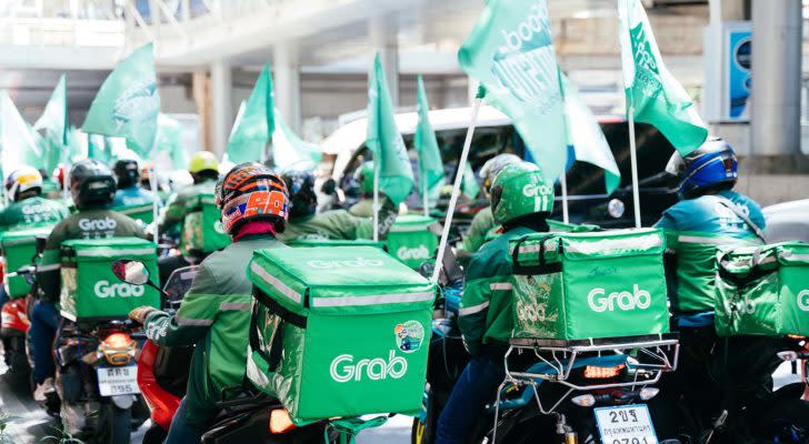 A group of Grab riders on motorbikes in Bangkok, Thailand.