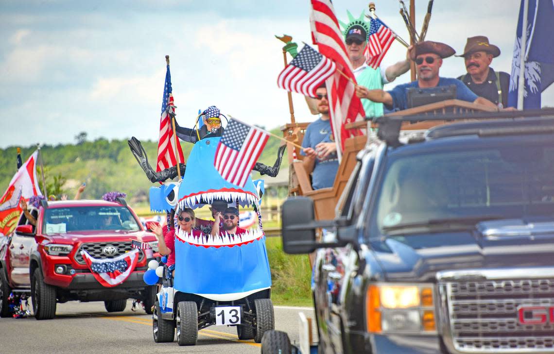 The “Carolina Nature Shark” golf cart won second place, best float. Lauren and Levi Volk, of Sydney , Australia, wave on the parade route. Their parents live in Pawleys Island.