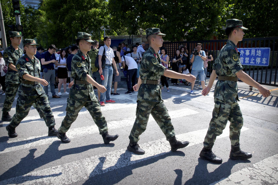 <p>Chinese paramilitary police march in formation past the site of an incident near the U.S. Embassy in Beijing, Thursday, July 26, 2018. (Photo: Mark Schiefelbein/AP) </p>