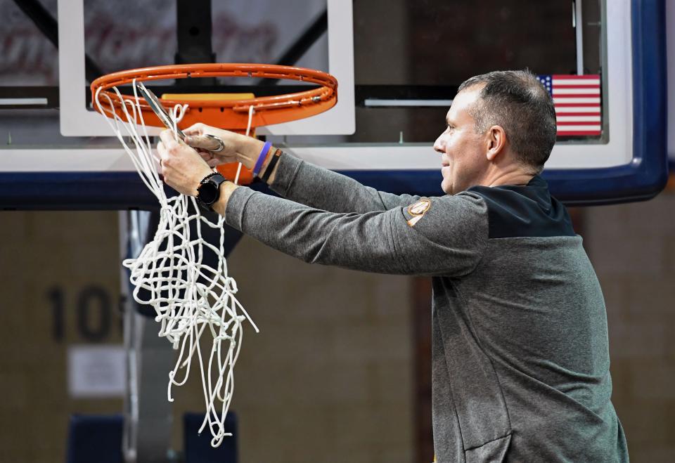 Washington head coach Jamie Parish cuts down a game net after the team’s win in the girls class AA state basketball championship on Saturday, March 11, 2023, at the Sanford Pentagon in Sioux Falls.