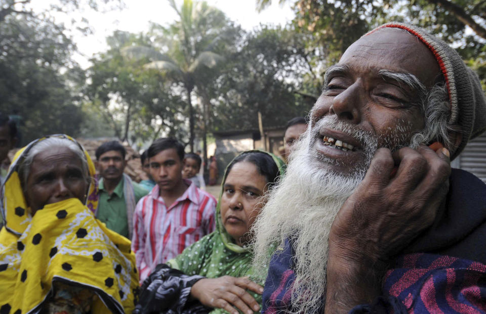 A Bangladeshi man, right, reacts as he looks for his son's body outside a garment factory where a fire killed more than 110 people Saturday on the outskirts of Dhaka, Bangladesh, Monday, Nov. 26, 2012. Bangladeshis Monday blocked the streets near Dhaka, throwing stones at factories and smashing vehicles, as they demanded justice for those killed in the fire. Saturday's blaze highlighted unsafe conditions in an industry producing for retailers around the world. (AP Photo)