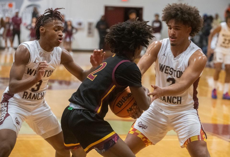Weston Ranch's Elliot Mobley, left, and Khristian Holmes double team Edison's Jehahn Williams during a boys varsity basketball game at Weston Ranch in Stockton on Wednesday, Jan. 4, 2023.