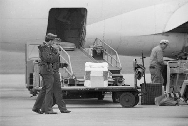 Caskets of murdered Olympians carried onto a plane