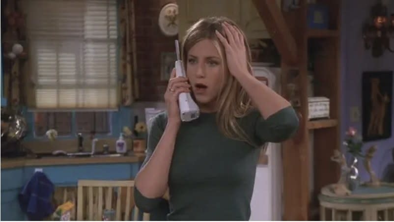 Rachel looking stunned on the phone