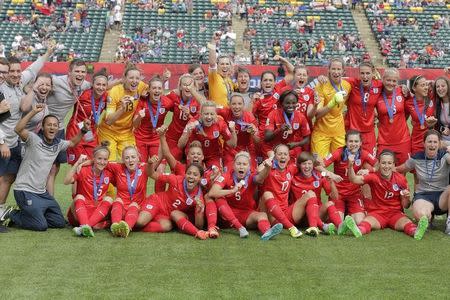 Jul 4, 2015; Edmonton, Alberta, CAN; England players and bench personnel pose with their medals after their victory over Germany in the third place match of the FIFA 2015 Women's World Cup at Commonwealth Stadium. England defeated Germany 1-0 in extra time. Mandatory Credit: Erich Schlegel-USA TODAY Sports