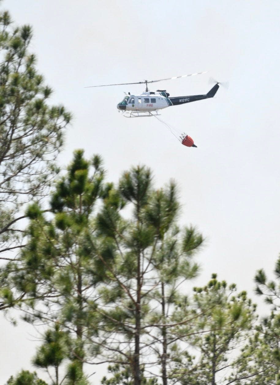 The Florida Forest Service battles a wildfire that stemmed from a prescribed burn conducted Friday in the Garcon Point area.