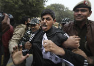 Policemen detain students protesting outside Uttar Pradesh Bhawan during a protest against a new citizenship law and violence by police in the state, in New Delhi, India, Friday, Dec. 27, 2019. The new citizenship law allows Hindus, Christians and other religious minorities who are in India illegally to become citizens if they can show they were persecuted because of their religion in Muslim-majority Bangladesh, Pakistan and Afghanistan. It does not apply to Muslims. (AP Photo/Manish Swarup)