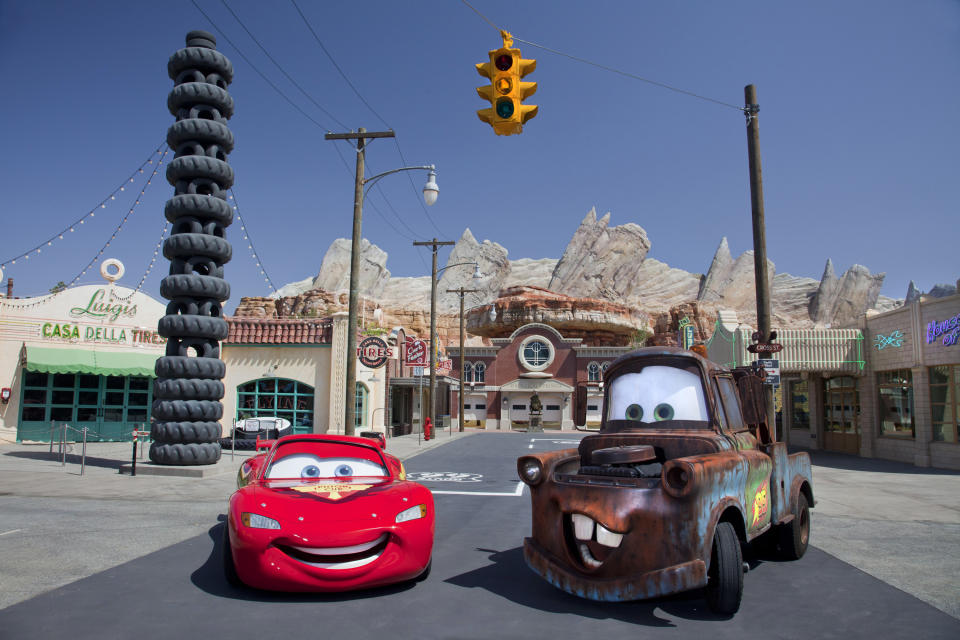 This May 2012 photo released by Disneyland shows characters Lightning McQueen, left, and Mater at the new 12-acre Cars Land, a replica of Radiator Springs, the town in the popular "Cars," film franchise at Disney California Adventure park at Disneyland Resort in Anaheim, Calif. The park's five-year, $1 billion-plus revamp has debuted in spurts since 2008. Most of its new features rely on characters that come from Disney's $7.4 billion acquisition of Pixar Animation Studios, the San Francisco-area studio behind "Cars," `'Toy Story," `'Monsters Inc." and "A Bug's Life." (AP Photo/Disneyland Resort, Paul Hiffmeyer)