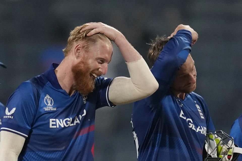 England's captain Jos Butler and Ben Stokes celebrate their win over Netherlands in the ICC Men's Cricket World Cup match in Pune, India, Wednesday, Nov. 8, 2023. (AP Photo/Rafiq Maqbool)