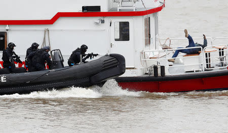 Armed counter terrorism officers of the London Metropolitan Police, take part in a training exercise to rescue hostages held by armed terrorists, played by actors, from a cruise boat on the river Thames, in London, Britain March 19, 2017. REUTERS/Peter Nicholls