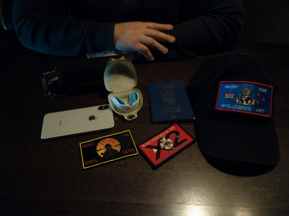 Chudaev shows his favorite possessions he carries in his backpack.<span class="copyright">Diego Fabro for TIME</span>