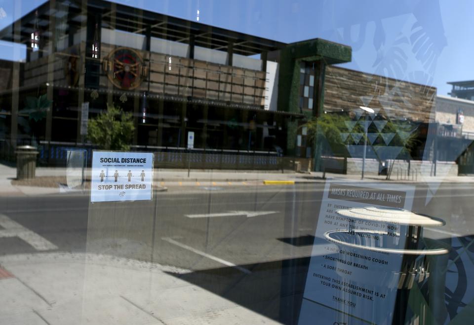 The closed El Hefe restaurant and bar is one of the many establishments closed for the next 30 days due to the surge in coronavirus cases, Tuesday, June 30, 2020, in Scottsdale, Ariz. (AP Photo/Ross D. Franklin)