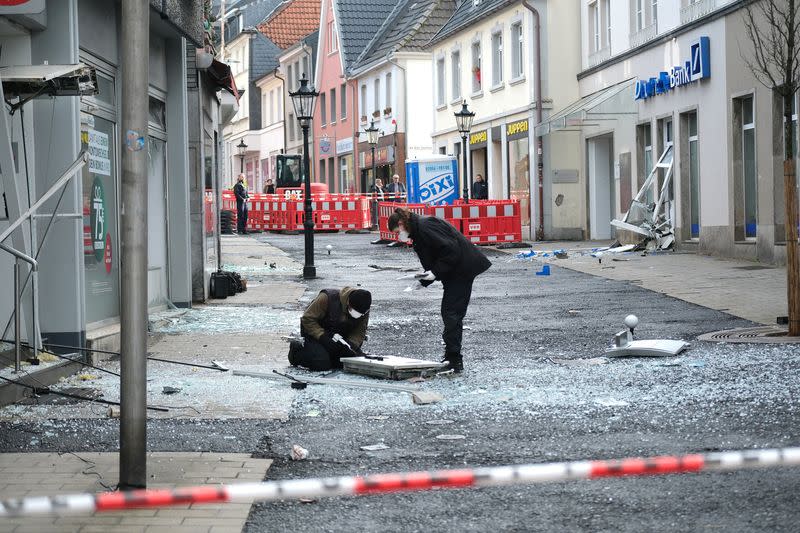 Law enforcement officers investigate the scene following an attack on bank ATMs in Ratingen