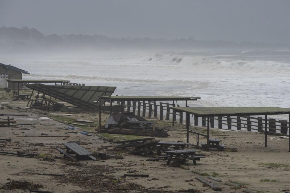 Picnic tables and debris are strewn about Seacliff State Beach.