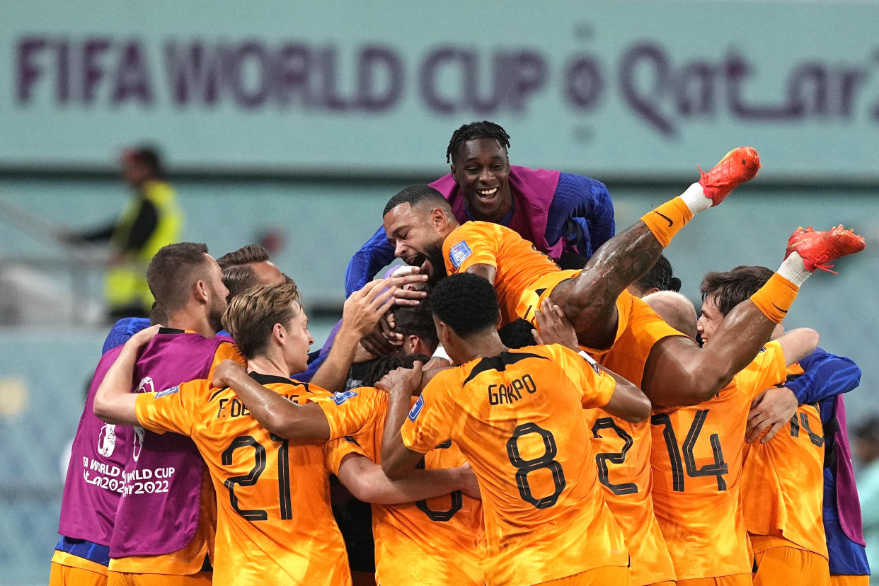 Players of the Netherlands celebrate their side's second goal by Daley Blind during the World Cup round of 16 soccer match between the Netherlands and the United States, at the Khalifa International Stadium in Doha, Qatar, Saturday, Dec. 3, 2022. (AP Photo/Martin Meissner)