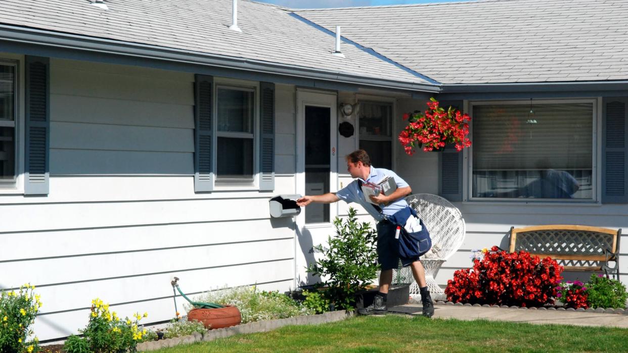 A mailman delivering mail.