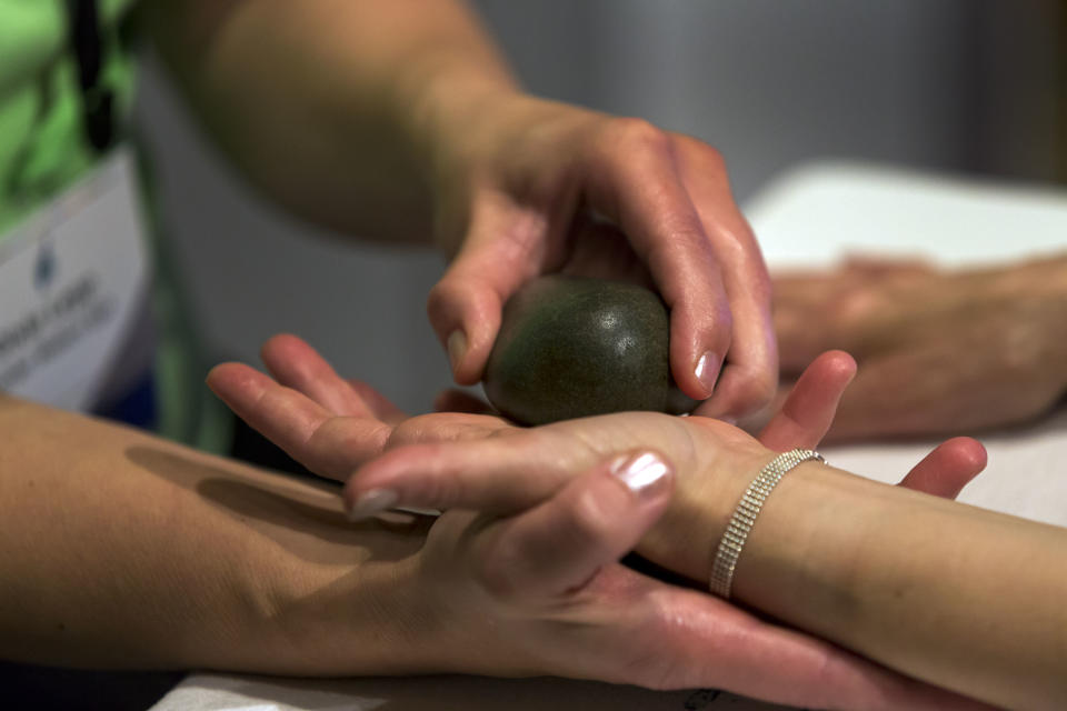 This Aug. 15, 2013 photo shows a woman receiving a Hand Rescue Citrus Reviver treatment from the Kohler Waters Spa, in Kohler, Wisc., at the International Spa Association event in New York. The 50-minute treatment includes lime exfoliating, a clementine moisturizer and a grapefruit scalp massage. (AP Photo/Richard Drew)