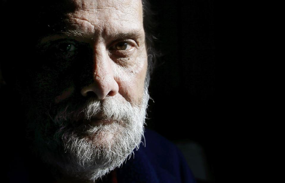 In this Sunday, Dec. 11, 2016 photo U.S. Navy veteran Stephen Matthews, 55, sits for a photograph in the bedroom of a relatives home, in Warwick, R.I. Matthews said he received a voucher that would pay about two-thirds of his rent, but struggled to find an apartment in Rhode Island where he could afford the balance. He got one in West Warwick, R.I. in late December 2016 after a six-month search. (AP Photo/Steven Senne)